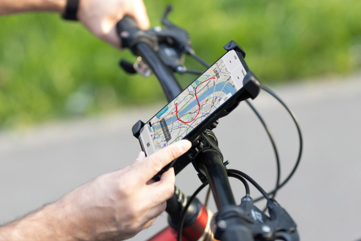Man planning route using GPS navigation application in mobile phone on his bicycle bike.