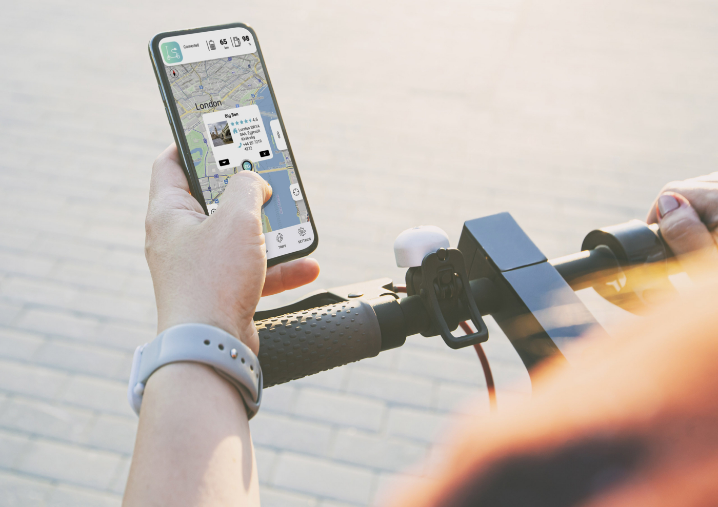 Girl standing with electric scooter and showing the phone with b